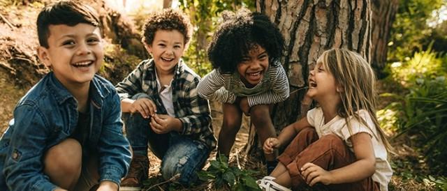 Children laughing under a tree